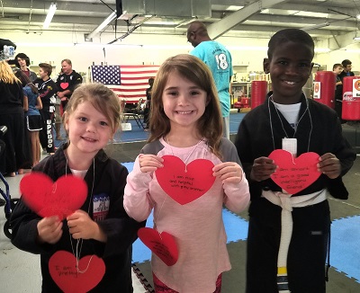Students holding cards from Bully Prevention Seminar